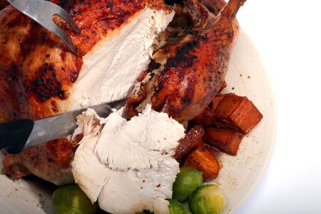 Carving a turkey, viewed from above as the person serving would see it.の写真素材