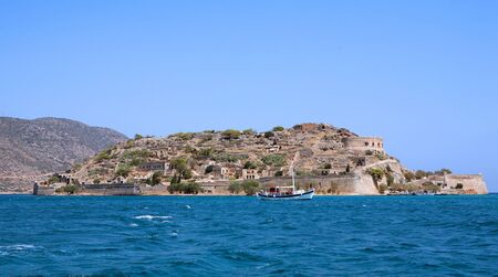 The fortress island of Spinalonga, Crete, a leper colony a century ago, seen from Elounda side.の写真素材