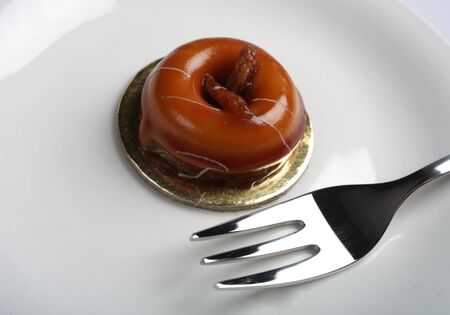 A gourmet miniature caramel cake with a fork.の写真素材