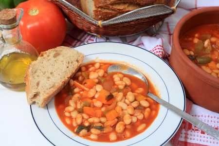 A meal of Greek white bean soup, made with dried beans, tomato, onion, olive oil, carrots, celery, and capsicum. This is described by one authority as "the soup that feeds Greece" and is an important element in the Mediterranean diet.の写真素材