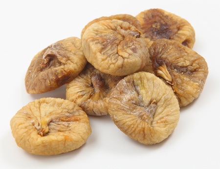 Dried figs in a pile on a white background の写真素材