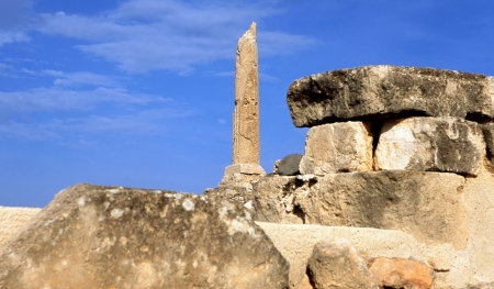 A lone pillar of the prehistoric Greek temple to Apollo stands amid the ruins of ancient Aegina, a stoneの写真素材