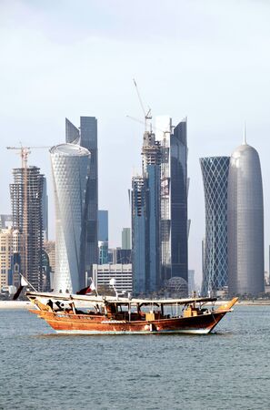 A pair of dhows moored in Doha Bay, Qatar, with the Arabian capital city