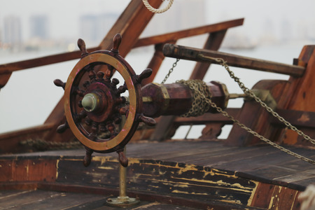 The wheel of a traditional sailing dhow, showing the arrangement of chains and their attachment to...