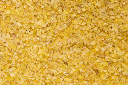 Macro photograph of raw, light-coloured, fine-ground burghul or bulgur wheat, a staple of the Middle Eastern diet and considered a health food in the West as it has a lower glycemic index than white rice and more fibre and minerals.の写真素材
