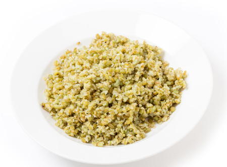 A bowl of freshly boiled cracked freekeh scorched green wheat grains, one of the "paleo superfoods". It can be eaten as it is or used in a wide range of dishes.の写真素材
