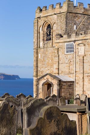 The church and graveyard of St Mary the Virgin, next to the ruins of Whitby Abbey, Yorkshire, UKの写真素材