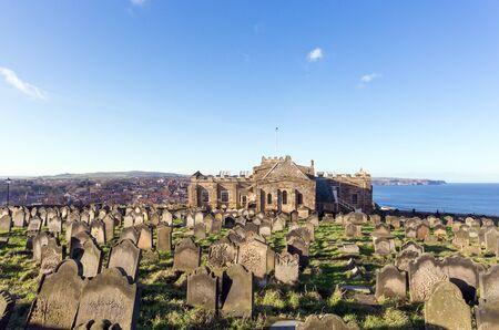 The crowded graveyard of the Norman era St Mary the Virgin C of E church in the Yorkshire coastal town on Whitby. The graveyard was used in the 1700s and 1800s.の写真素材