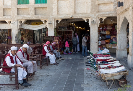 DOHA, QATAR - MARCH 8, 2015: Porters with their barrows await work outside part of the imposing Souq Waqif tourist attractionのeditorial素材