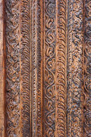 DOHA, QATAR - MARCH 8, 2015: Detail of traditional Arab carving on an antique door frame in Souq Waqif shopping area, a popular tourist attraction.のeditorial素材