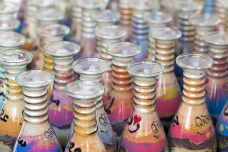 DOHA, QATAR - MARCH 8, 2015: Sand-filled glass bottles sold as souvenirs of Qatar in the Souq Waqif...