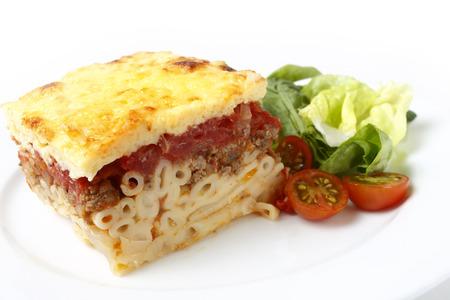 Traditional Greek pastitsio with a salad of tomatoes, lettuce and spinachの写真素材