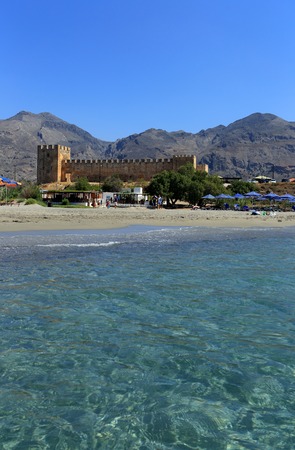 FRANGOKASTELLO, CRETE - JULY 3, 2016: Tourists relax next to the limpid sea  beside the castle at Frangokastello, south Crete. Visitor numbers on the island were up 12% in July.のeditorial素材