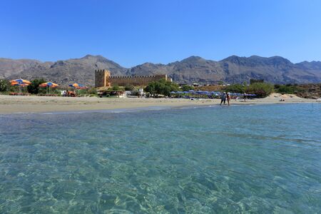 FRANGOKASTELLO, CRETE - JULY 3, 2016: Tourists relax next to the limpid sea  beside the castle at Frangokastello, south Crete. Visitor numbers on the island were up 12% in July.のeditorial素材