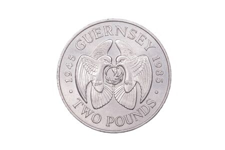 A two pound coin from the Bailiwick of Guernsey commemorating forty years of peace time after the end of the second world war. It is dated 1985 and featured two doves with an olive branchの写真素材