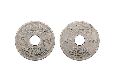 A five Milliemes coin from Egypt minted in 1917 and featuring a hole through the middle of the coin set on a white background.の写真素材