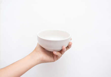 Hand of a young man holding a bowl of food isolated on a white background