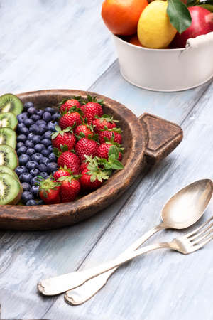 Fresh and various fruits isolated in a shabby chic background. verticalの写真素材