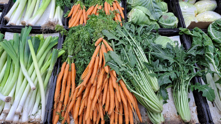 Carrots and leek in the vegetable market, closeup of photoの写真素材