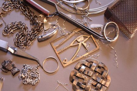 Close up of work in progress on a silversmiths bench.の写真素材