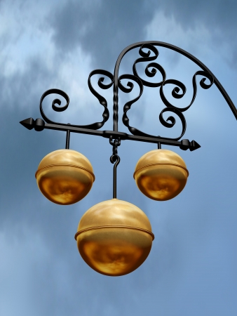 Pawnbroker shop sign with three golden ballsの写真素材