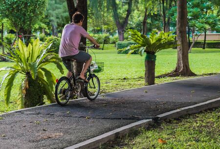 A man ride bicycle on bike lane in the parkの写真素材