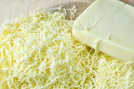 close up grated cheddar cheese,selective focus.の写真素材
