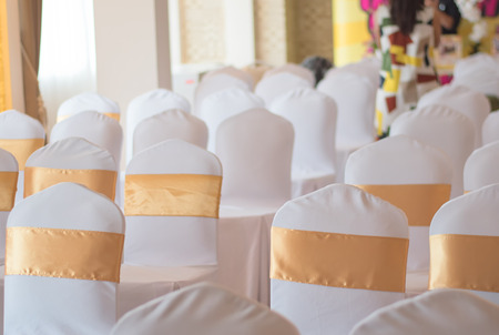 beautiful chairs decoration with ribbon in wedding event hall,selective focus.の写真素材