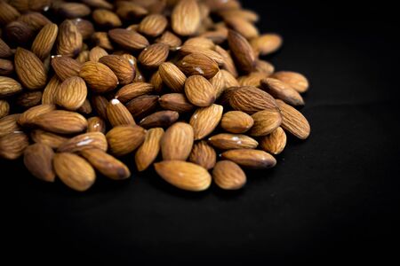 close up almonds nuts on black background,selective focus.の写真素材