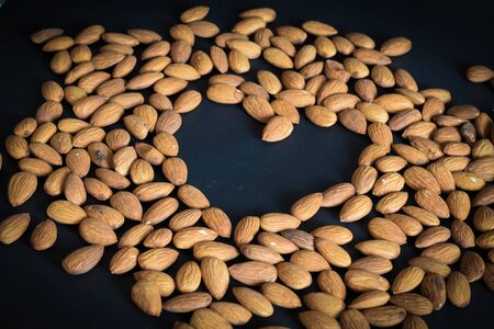 close up almonds nuts on black background,selective focus.