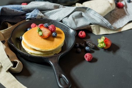 pancake with fresh fruit and berry stack on pan fot breakfast bakery,selective focus.の写真素材