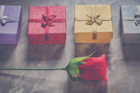 valentine's day background,red heart with red white rose ,ribbon and present box decoration,selective focus,vintage filter.の写真素材