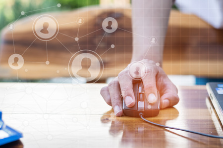 business technology concept,Business people hands use laptop connection online networking communication on table with social network icon symbol ,selective focus. の写真素材