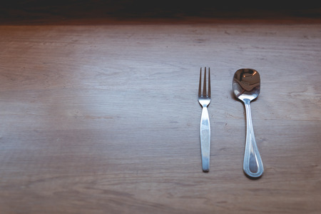 spoon fork on wood table , kitchenware of restaurant background with copyspace, selective focus.の写真素材