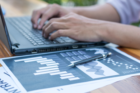business technology concept,Business people hands use laptop connection online networking communication on table ,selective focus. の写真素材