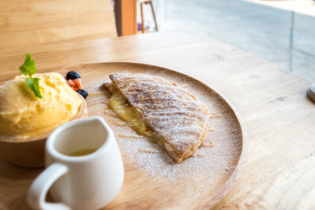 fresh dessert soft vanila roti with ice cream ,syrup ,strawberry and blueberry on plate in restaurant ,selective focus.の写真素材