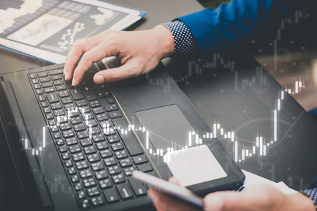 business trading concept : man trade stock and forex in notebook and analysis market financial data statistics chart for modern invesment ,selective focusの写真素材