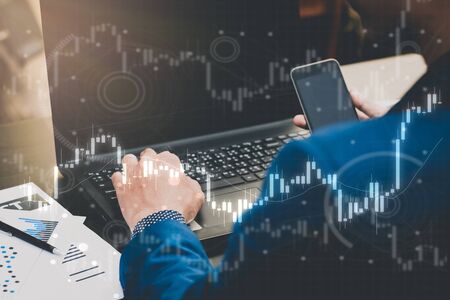 business trading concept : man trade stock and forex by laptop and analysis market financial data...