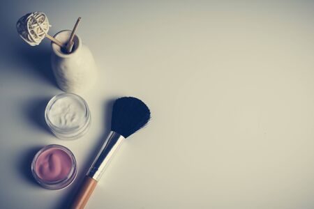 beauty concept : cosmetics top view on a white table. Workplace, cosmetic bag.の写真素材