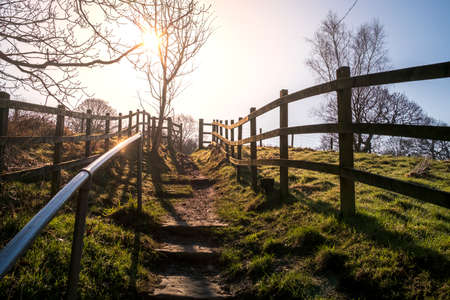 footpath in the country side steps leading up into the sun shine frosty winters morning