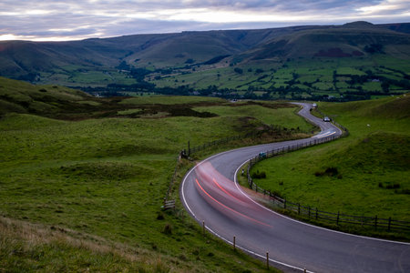 road out of Edale to Mam tor at sunset Peak district Derbyshire UK
