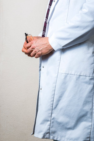 man wearing a white lab coat on a white backgroundの写真素材