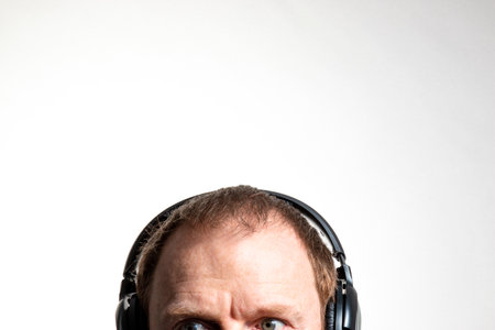 Man with headphones on a white background. Copy space for text.