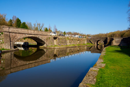 reflections in the canal spring sunshine bridge over the waterの写真素材