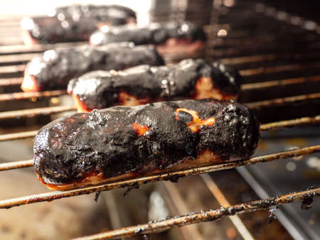 burnt over cooked sausages on the grillの写真素材
