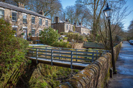 Bolton Lancashire UK April 2021 footbridge over stream to stone built country cottagesのeditorial素材