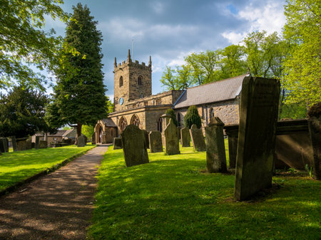 Eyam village church and grave yard on a sunny summers day known as the plague villageの写真素材