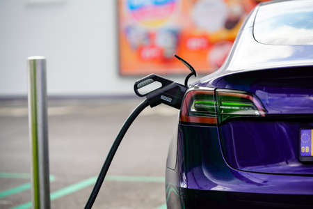 modern electric car being charged at public charging point