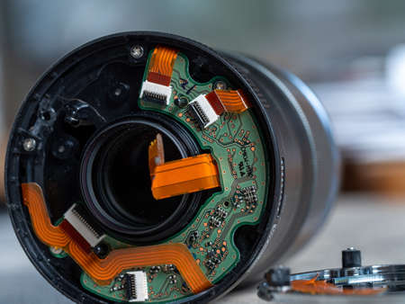 internal view of broken camera lens showing printed circuit board and electronicsの写真素材