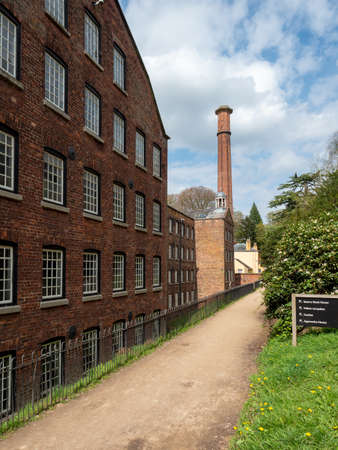 Styal Cheshire UK April 17, 2022 Quarry bank cotton mill main building and chimneyのeditorial素材